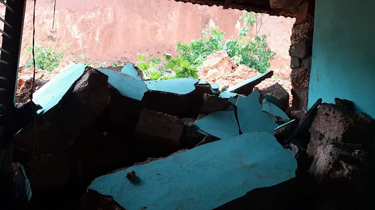 A portion of a house was damaged when a hillock caved in at Mallur Junction in Mangaluru taluk.
