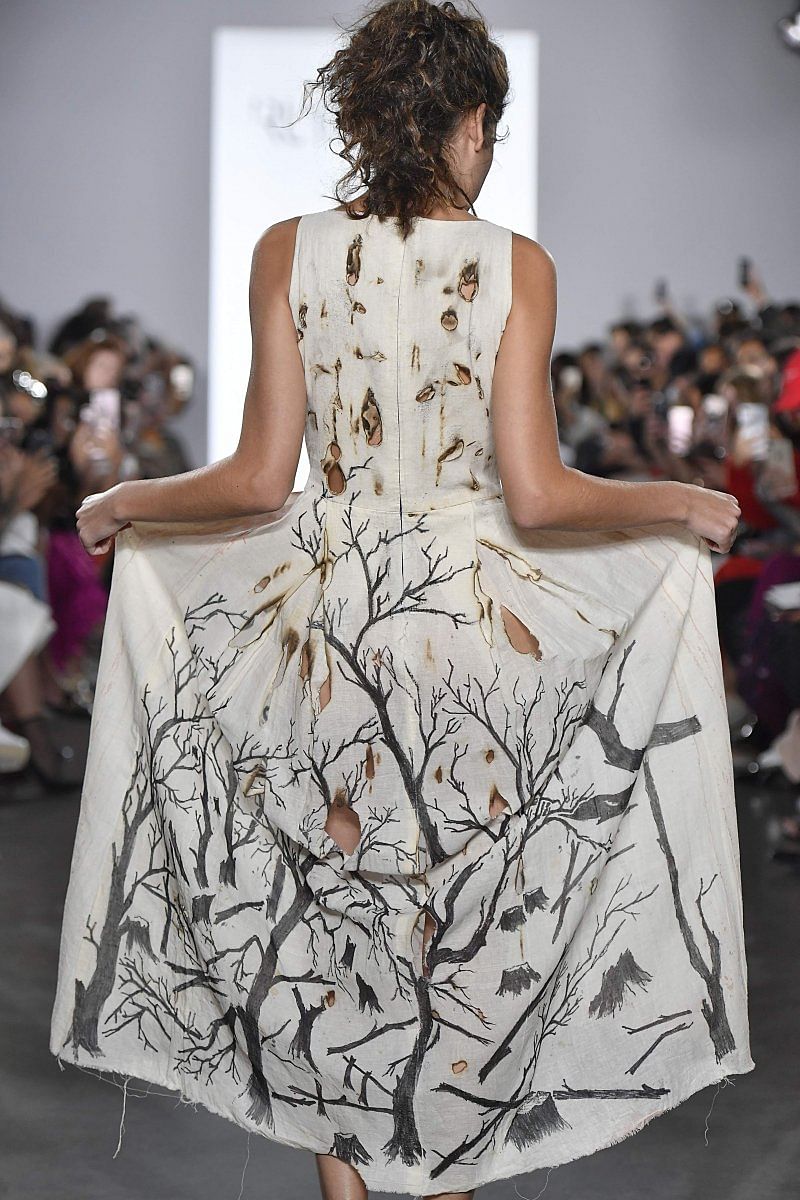 The back ofthe hand-painteddress showing thedestruction ofthe forests by man.