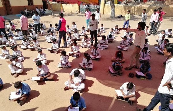 Children participating in the G P contest through a test.