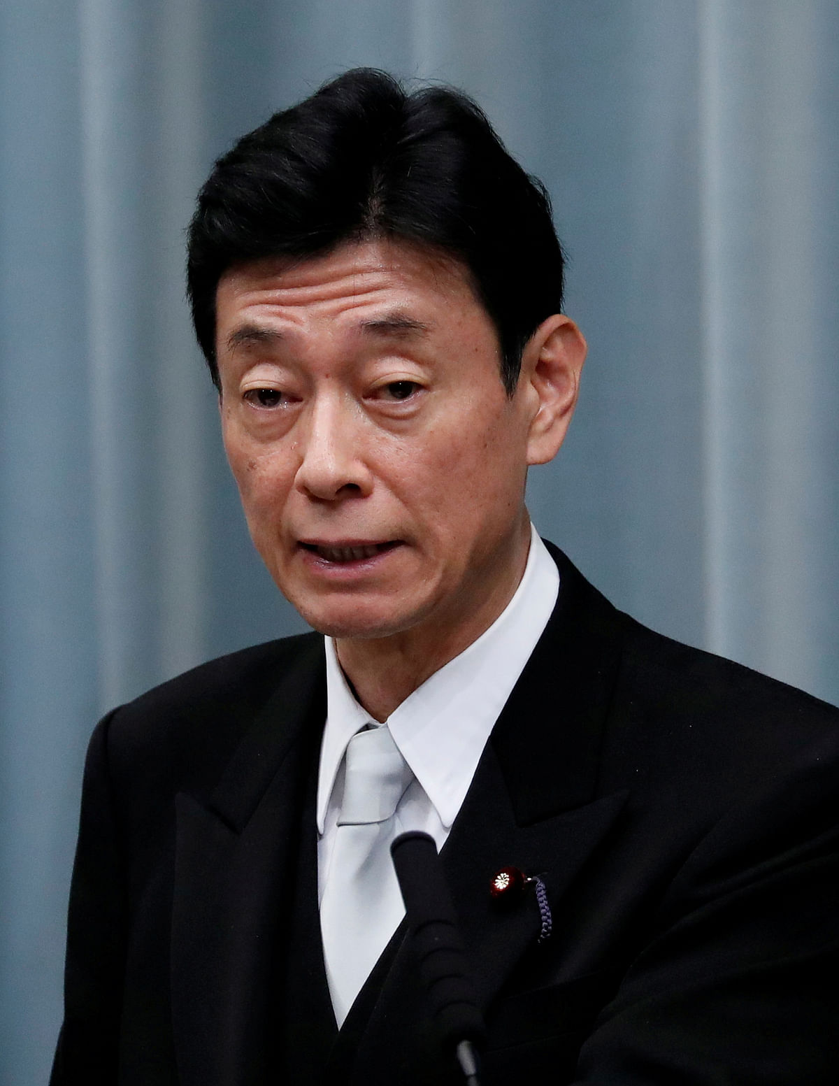 Japan's economy minister warns against premature fiscal, monetary steps to stimulate demand