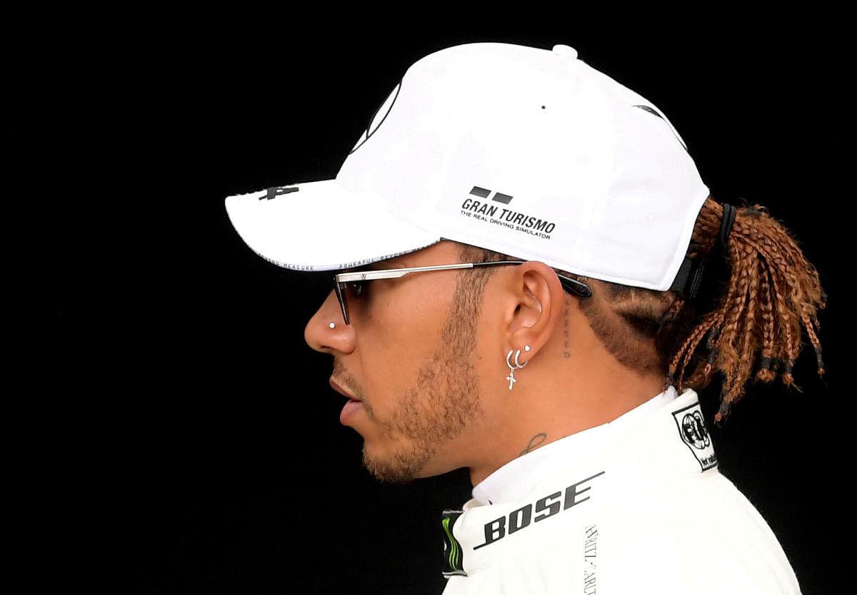 Hamilton on top with new black helmet as F1 roars back