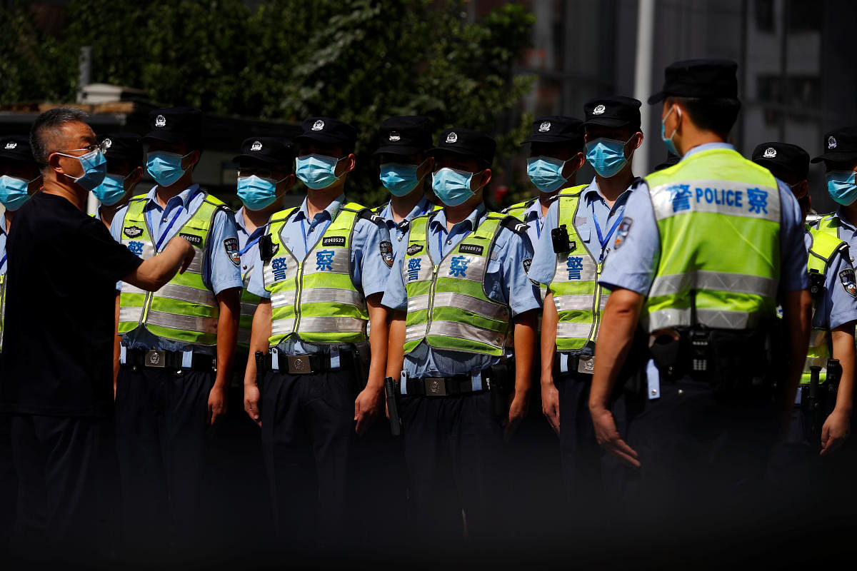 Police corral crowds as movers enter US Consulate in China