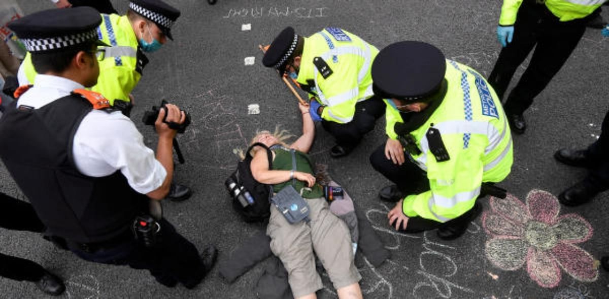 Climate activists glue themselves to street outside British parliament