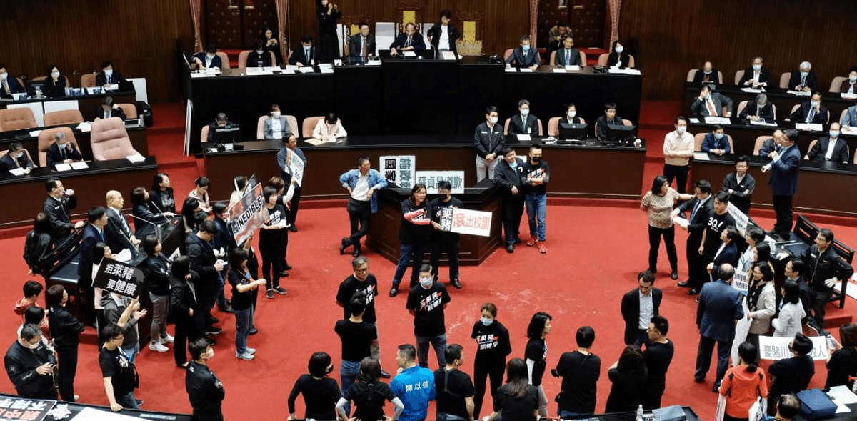 Lawmakers throw pig guts, punches on Taiwan parliament floor