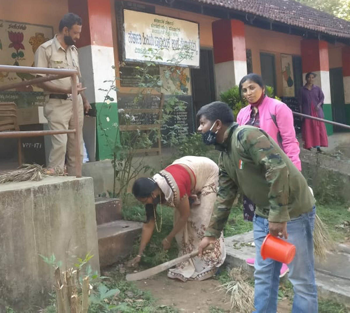 Polling officials clean school premises