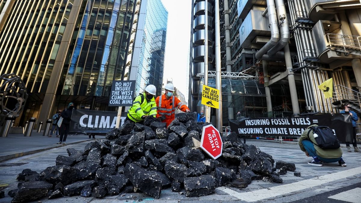 Activists dump fake coal outside Lloyd's in London, in fossil fuel protest
