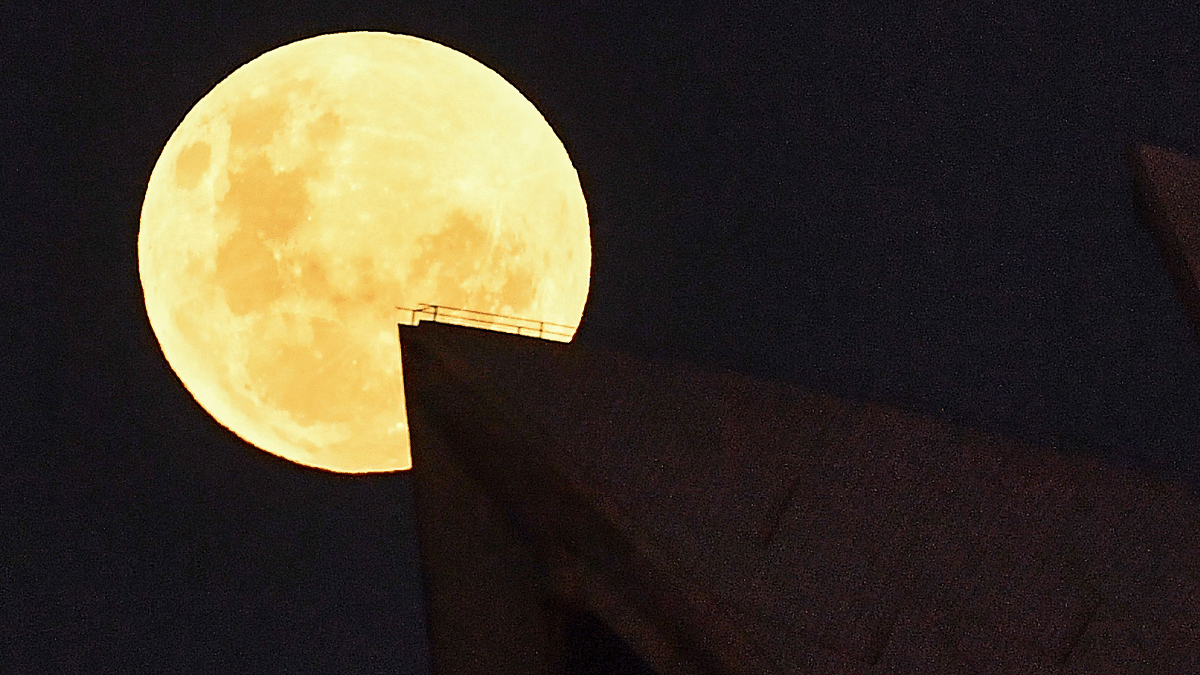Glittering moon rises ahead of super blood moon