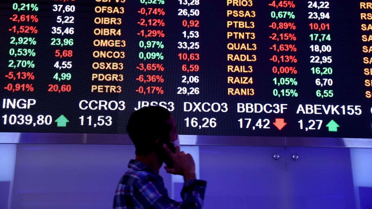 Asian shares inch lower as US dollar marches on