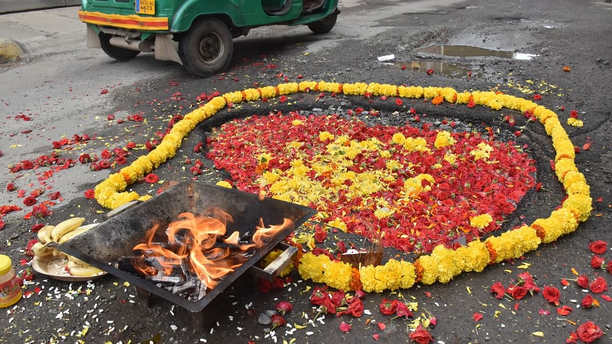 Residents perform puja on potholes in Bengaluru's Charles Campbell Road