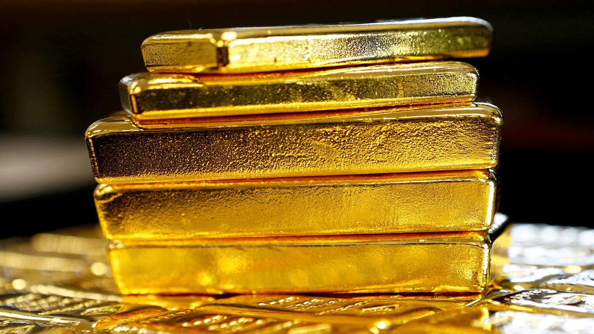 Gold eases from near record peak as dollar holds ground