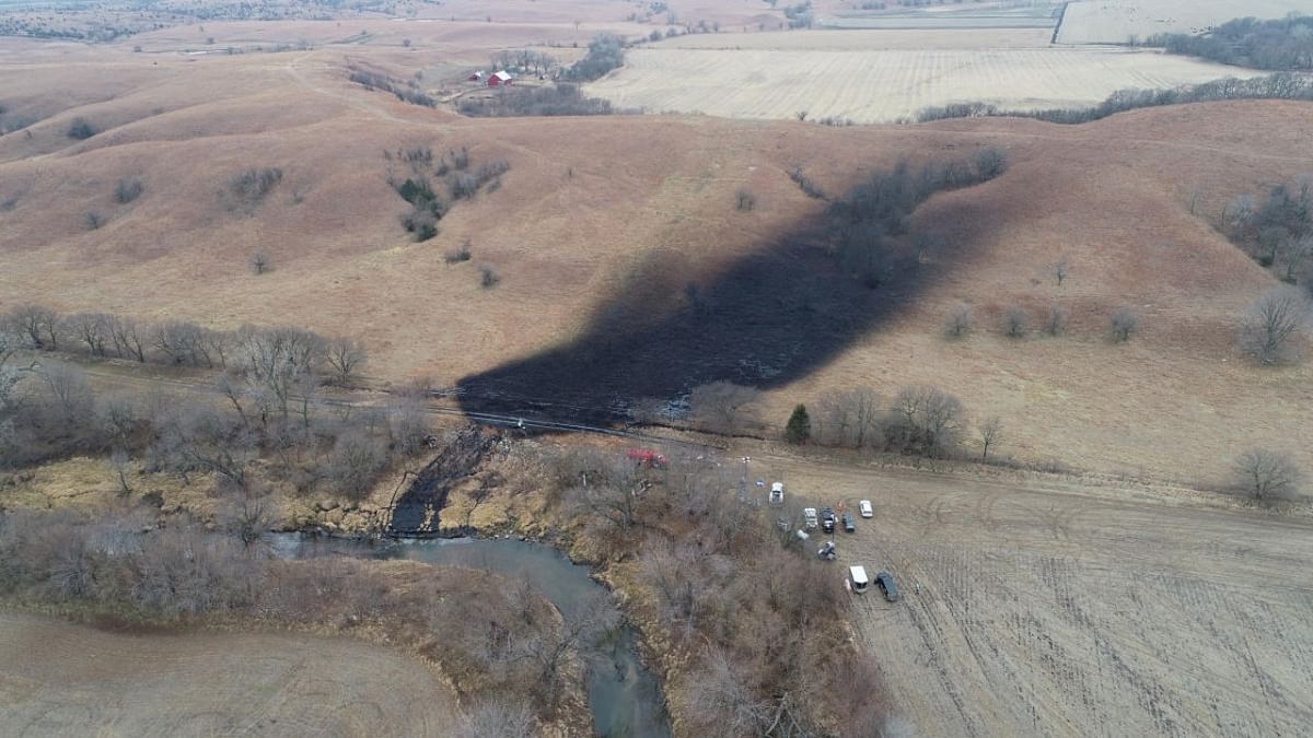 Residents hold their nose as crews mop up huge US oil spill