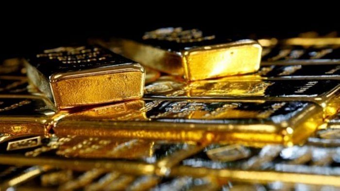 Gold rises on subdued dollar, US data in spotlight