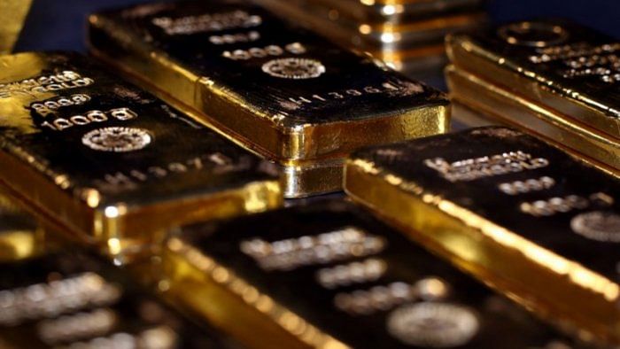 Gold muted after higher Fed rate signals, debt talks eyed