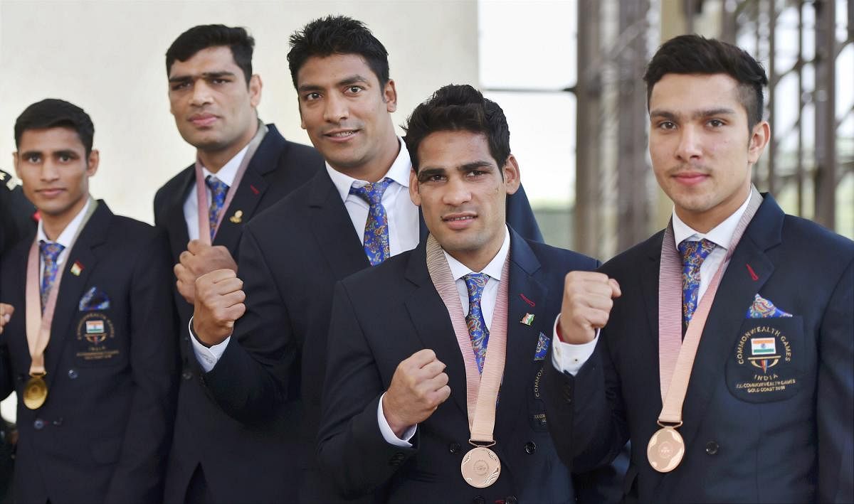 Commonwealth Games 2018, medal winners Indian Army's boxers and weightlifter Deepak Lather (R) pose for a photo at Manekshaw Centre in New Delhi on Wednesday. PTI