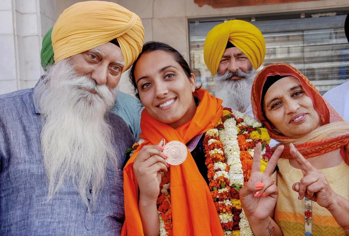 Commonwealth Games bronze medalist discus thrower Navjeet Kaur Dhillon being welcomed on her arrival in Amritsar on Wednesday. PTI