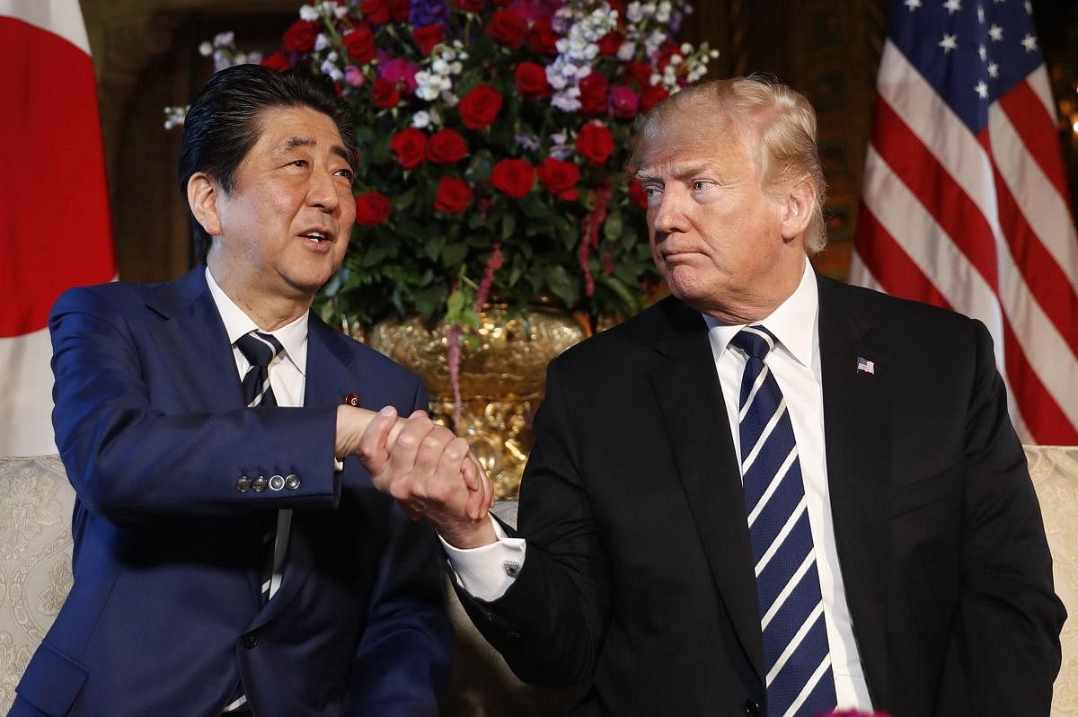 President Donald Trump and Japanese Prime Minister Shinzo Abe shake hands during a meeting at Trump's private Mar-a-Lago club, Tuesday, April 17, 2018, in Palm Beach, Florida. AP/PTI