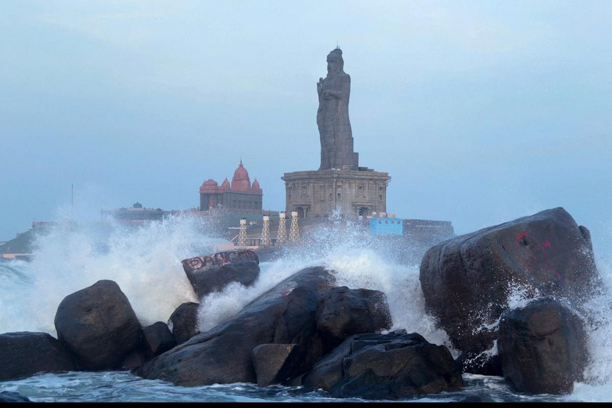 High waves hit the rocks around the Thiruvalluvar Statue in Kanyakumari on Sunday. Ferry services to Thiruvalluvar were temporarily suspended following Met department's announcement that high tidal waves were set to hit the coast. PTI Photo