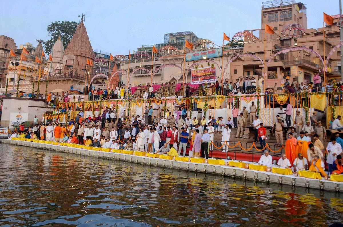 State Agriculture Minister Surya Pratap Shahi with priests and saints offer prayers at Dasammedh ghat on the occasion of Ganga Saptami in Varanasi on Sunday. PTI Photo