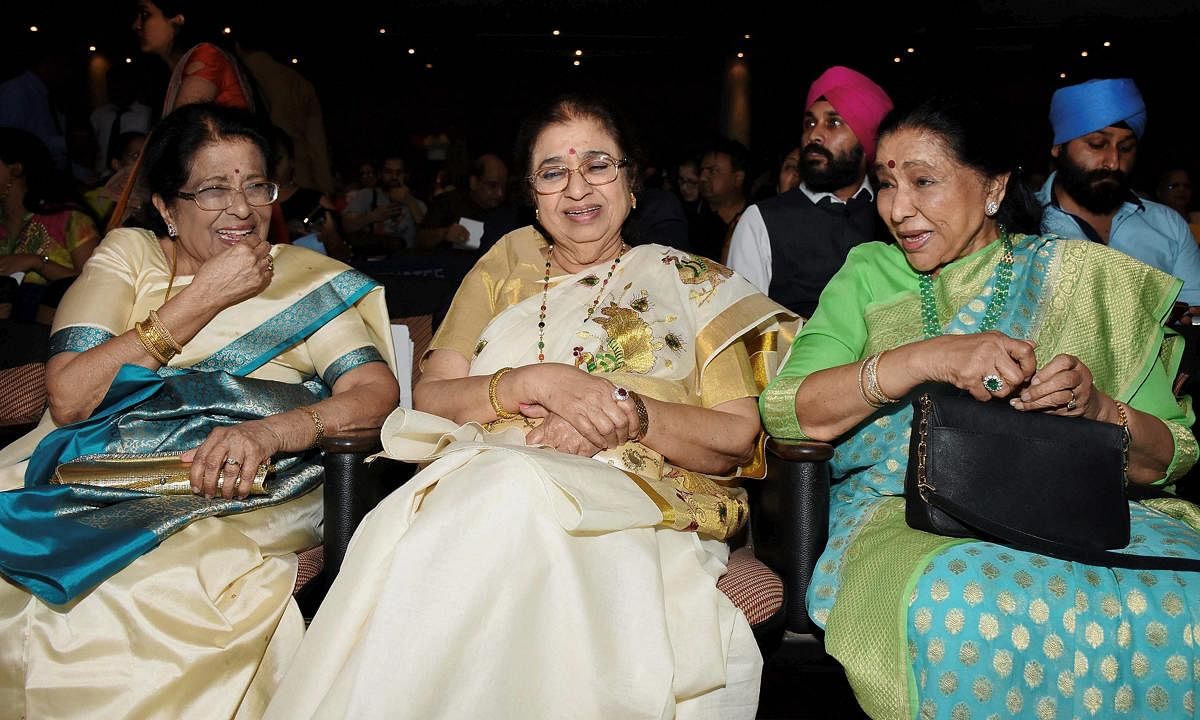 Singers Meena Mangeshkar, Usha Mangeshkar and Asha Bhosle during Master Deenanath Mangeshkar Smruti Pratishthan Awards in Mumbai on late Tuesday. PTI Photo