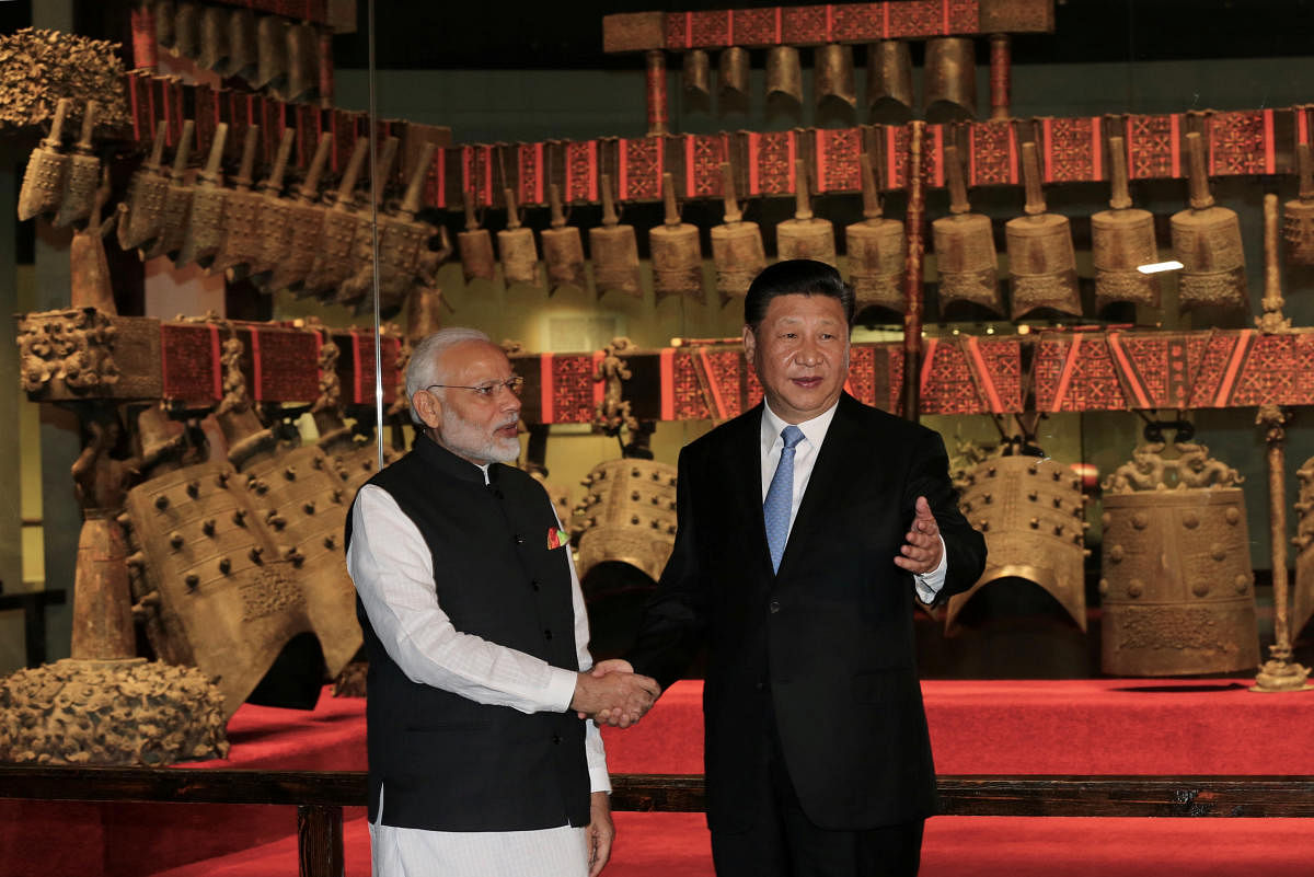 Chinese President Xi Jinping and Indian Prime Minister Narendra Modi shake hands as they visit the Hubei Provincial Museum in Wuhan, Hubei province, China April 27, 2018. China Daily via REUTERS