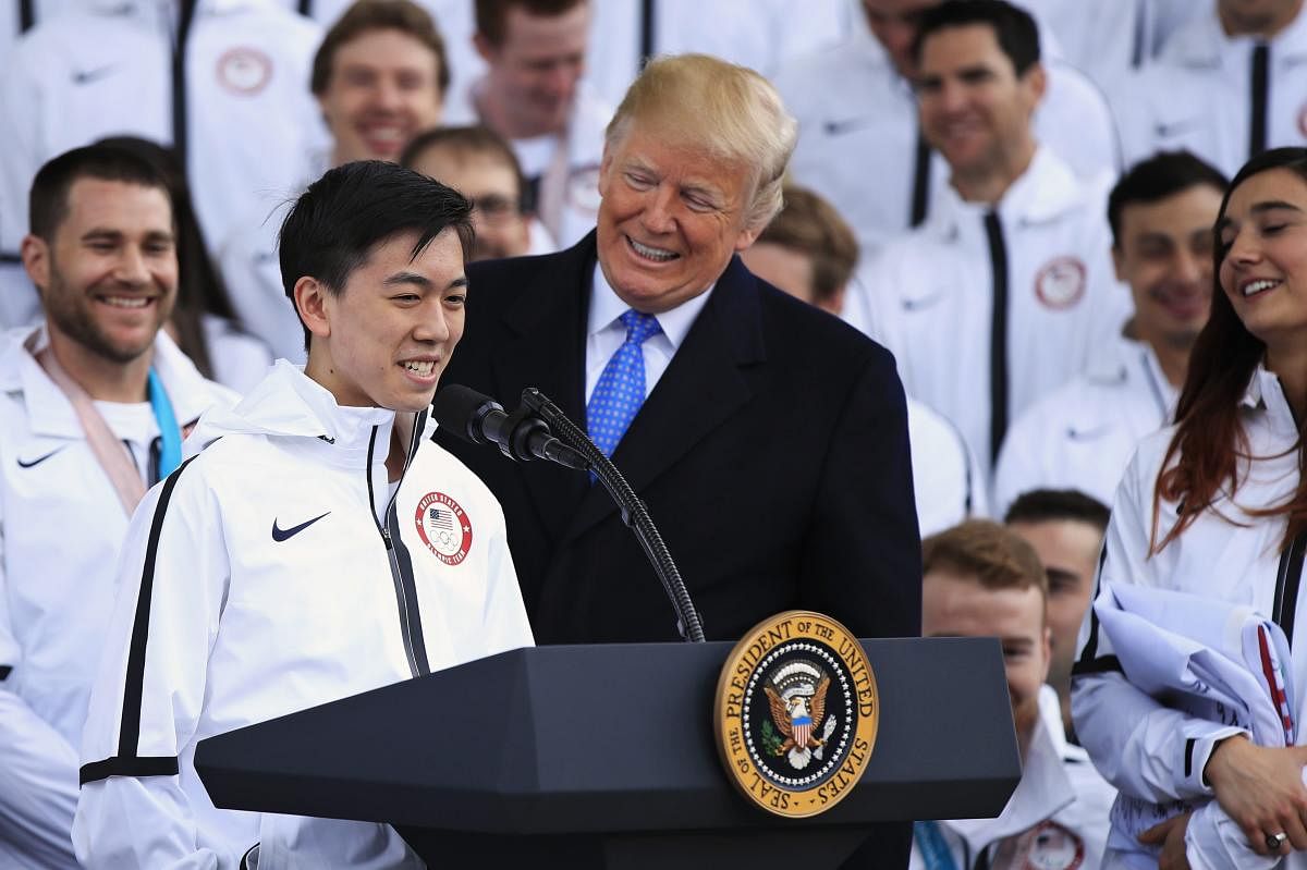 President Donald Trump listens to figure skater Vincent Zhou during a ceremony welcoming the Team USA Olympic athletes on North Portico at the White House in Washington, Friday, April 27, 2018. Zhou became the first figure skater to land a quadruple lutz in any Olympic Games when he completed the jump at the 2018 Winter Olympics. (AP/PTI)
