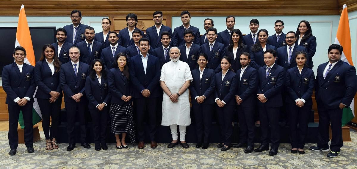 Prime Minister Narendra Modi with the medal winners of the Commonwealth Games 2018, in New Delhi on Monday. PTI Photo / PIB