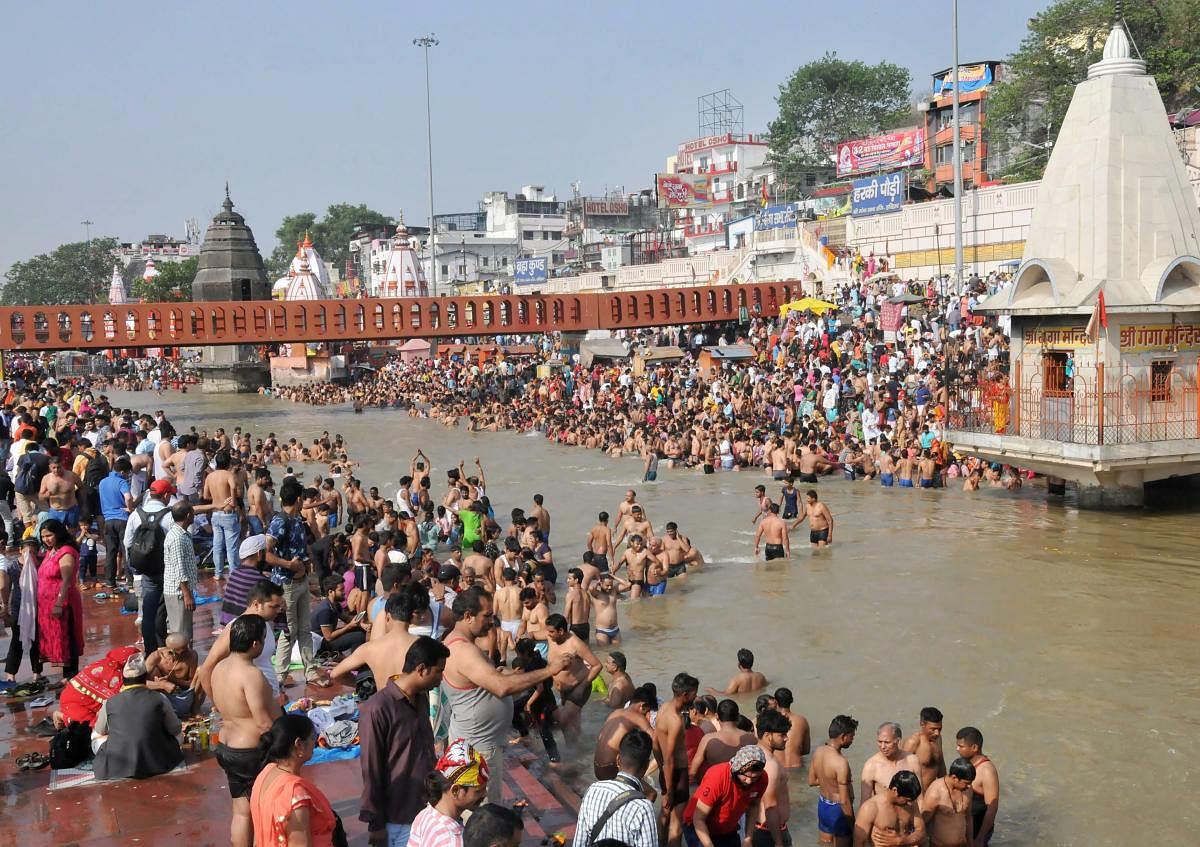 Hindu devotees take a holy dip and offer prayer at Har ki Paudi on the occasion of Buddha Purnima in Haridwar on Monday. PTI Photo