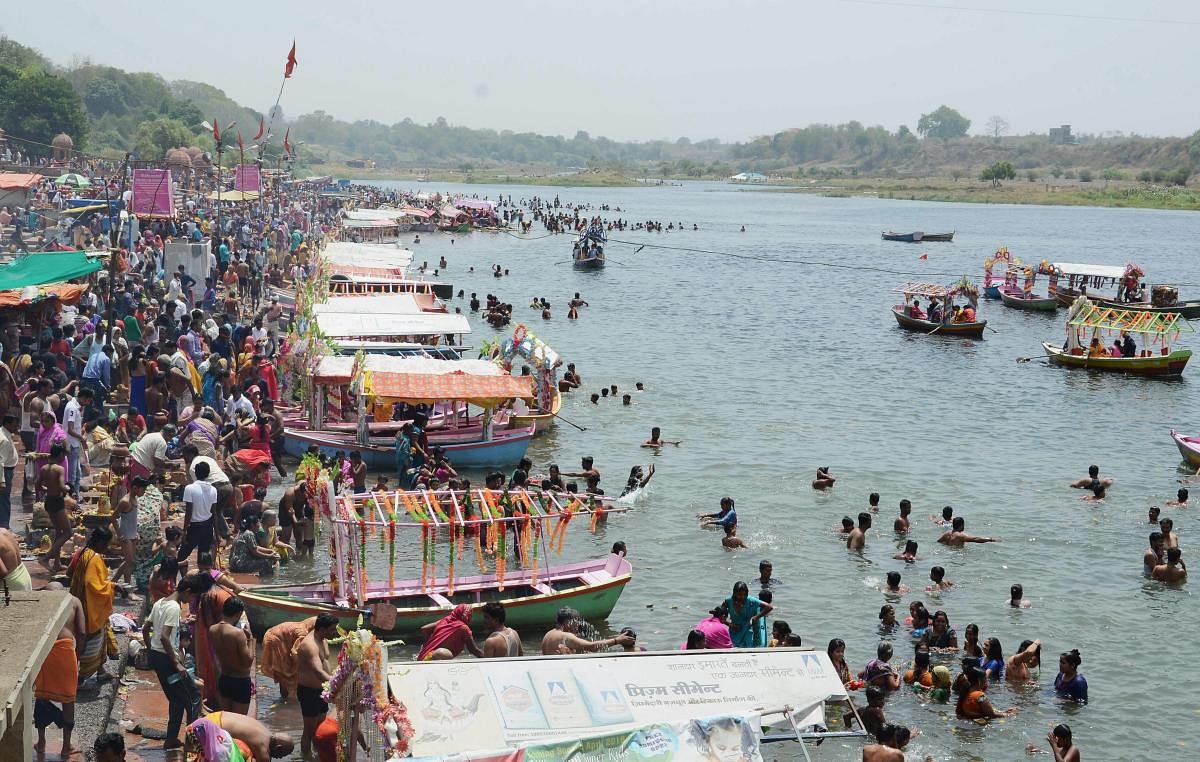 Devotees gather on the banks of the Narmada river to take bath on the occasion of Buddha Purnima, in Jabalpur on Monday. PTI Photo