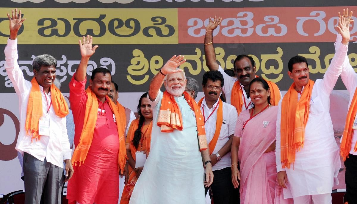 Prime minister Narendra Modi, along with the BJP leaders, waves at the crowd at an election campaign rally in Udupi on Tuesday, ahead of Karnataka polls. PTI Photo