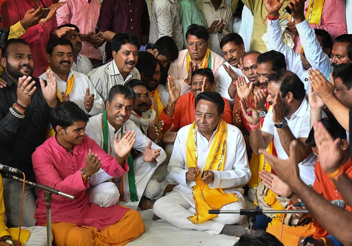 Newly appointed Madhya Pradesh Congress Committee President Kamal Nath takes part in a Hanuman Chaalisa recitation (prayers) at Gufa Mandir in Bhopal on Wednesday. PTI Photo