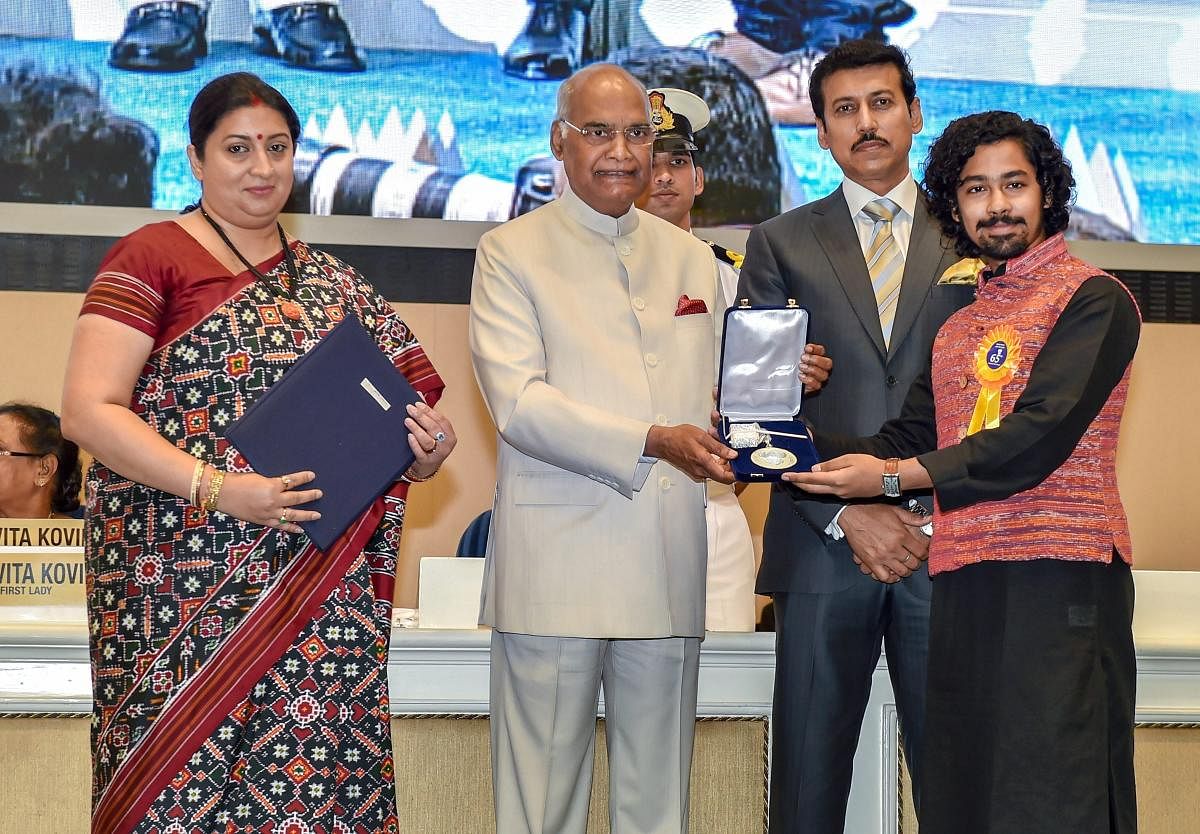 President Ram Nath Kovind confers Best Actor Award on Riddhi Sen during the 65th National Film Awards function at Vigyan Bhavan in New Delhi on Thursday. I & B MInister Smriti Irani and MoS for I & B Rajyavardhan Rathore are also seen. PTI Photo