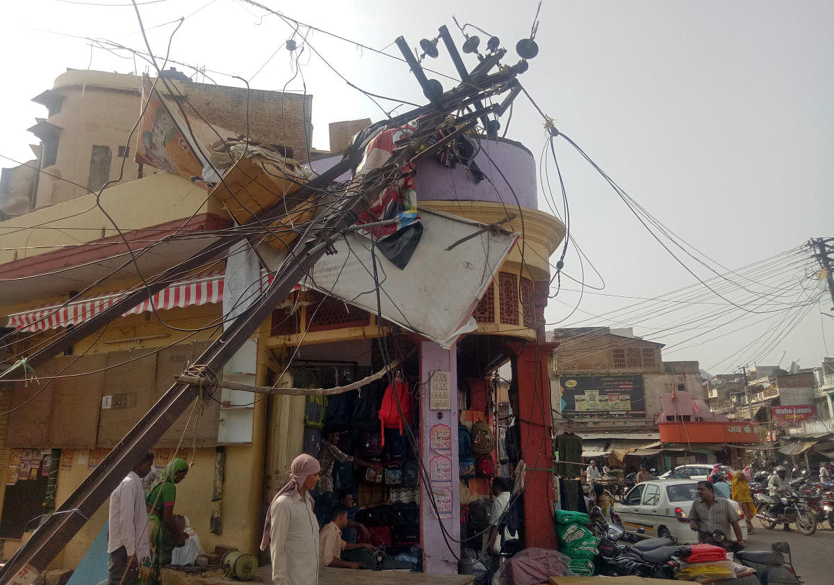 A damaged electric pole is pictured in a market after strong winds and dust storm in Alwar, in the western state of Rajasthan, India May 3, 2018. REUTERS