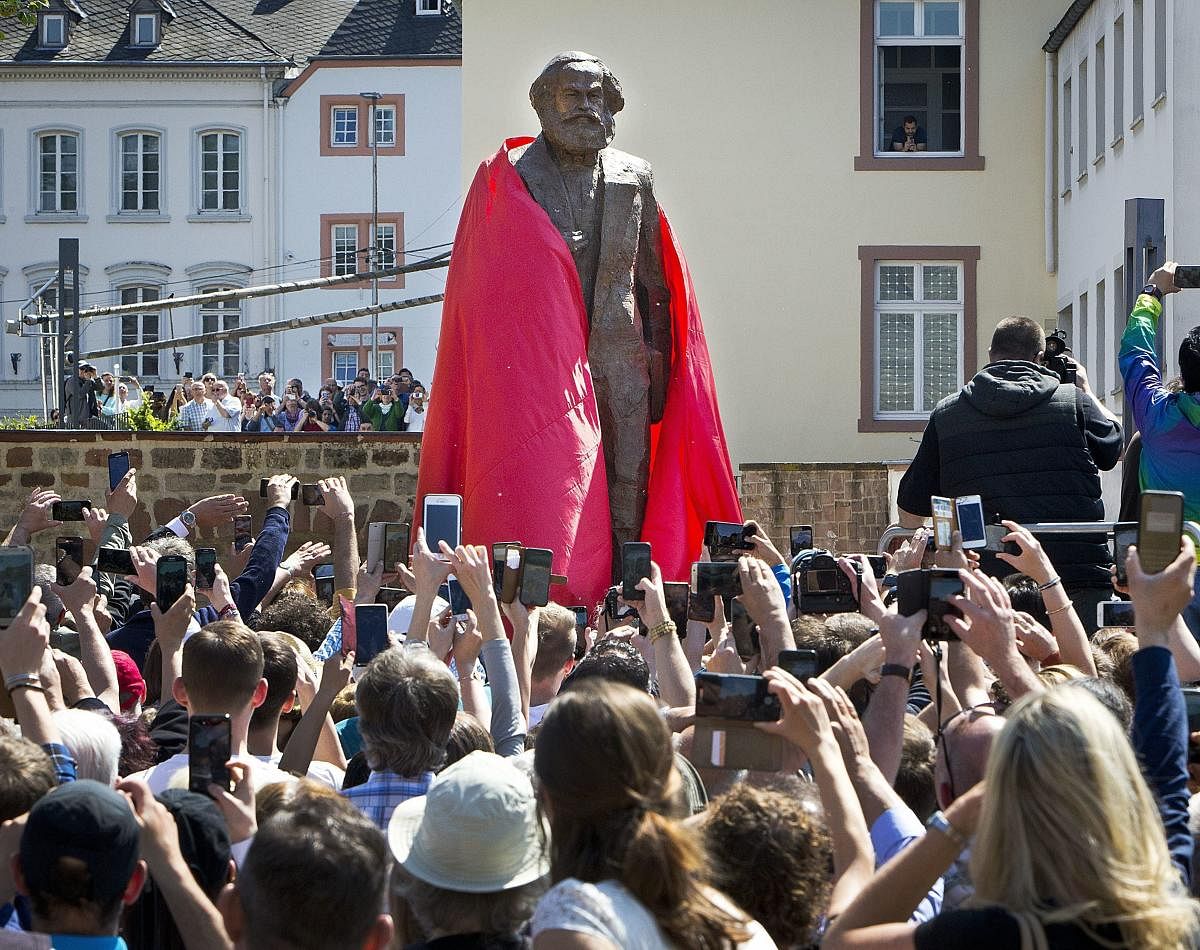 A bronze statue showing German philosopher Karl Marx is unveiled on occasion of the 200th birthday of Marx in Trier, Germany, Saturday, May 5, 2018. The statue was created by Chinese artist Wu Weishan and is a present of China. AP/PTI