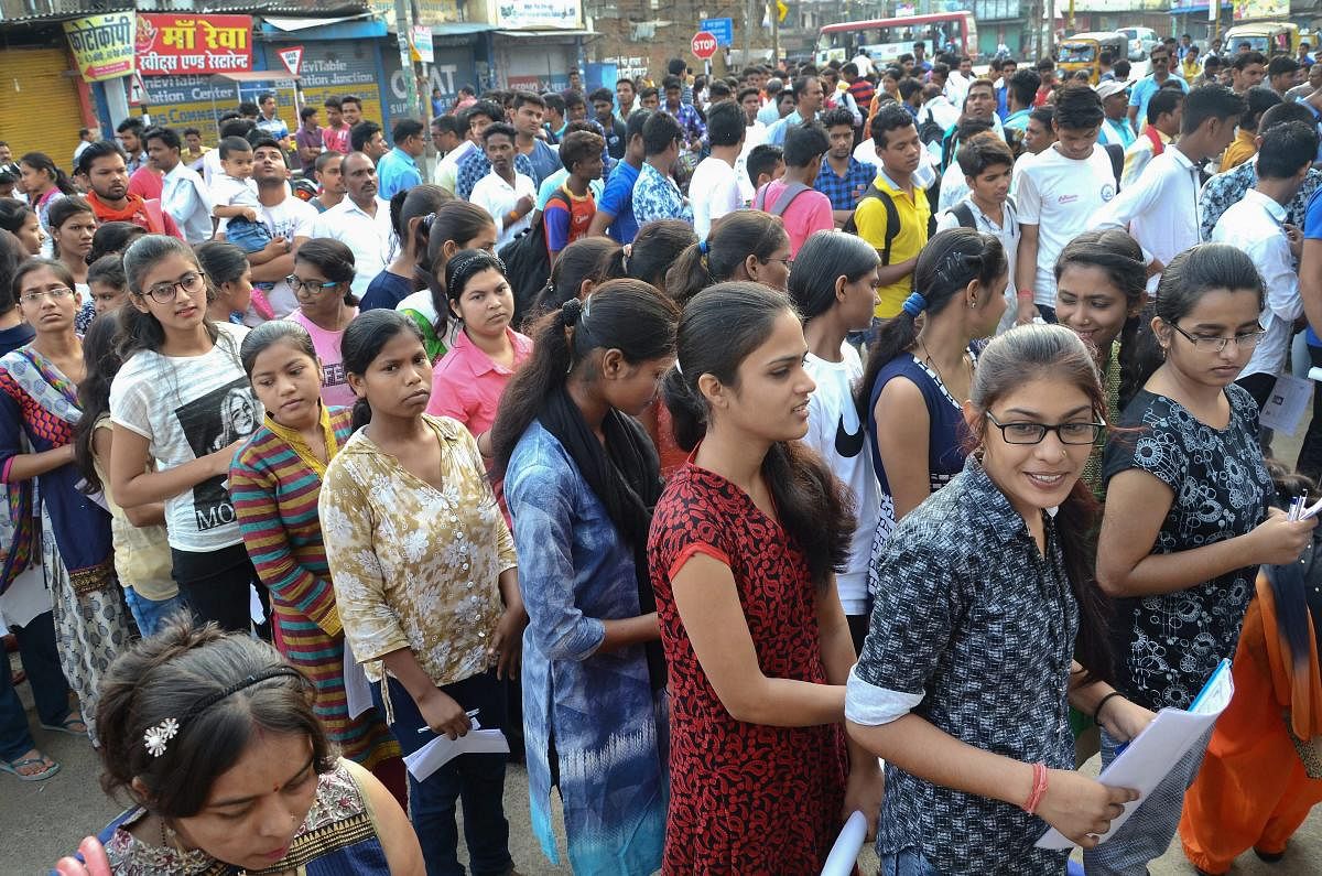 Applicants wait outside an examination centre to appear in the National Eligibility-Cum-Entrance Test (NEET) (UG) 2018 conducted by Central Board of Secondary Education (CBSE) in Jabalpur on Sunday. PTI