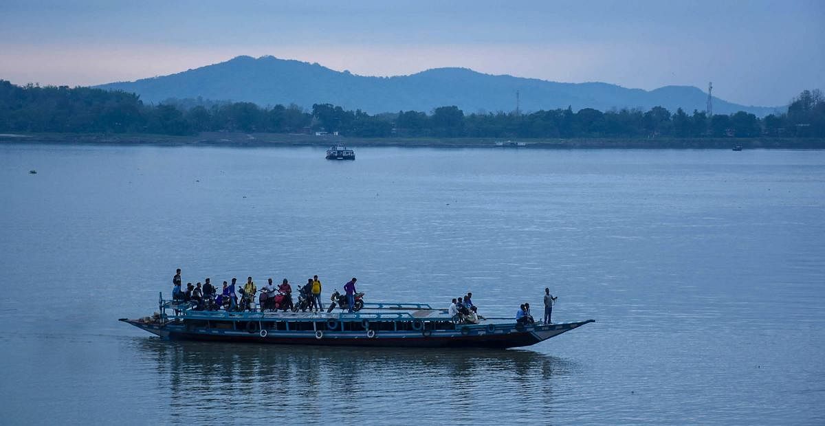 A passenger ferry crosses Brahmaputra river in Guwahati on Monday. With an increase in rainfall on the higher parts North-Eastern states there is a significant rise in the water level of Brahmaputra River. PTI