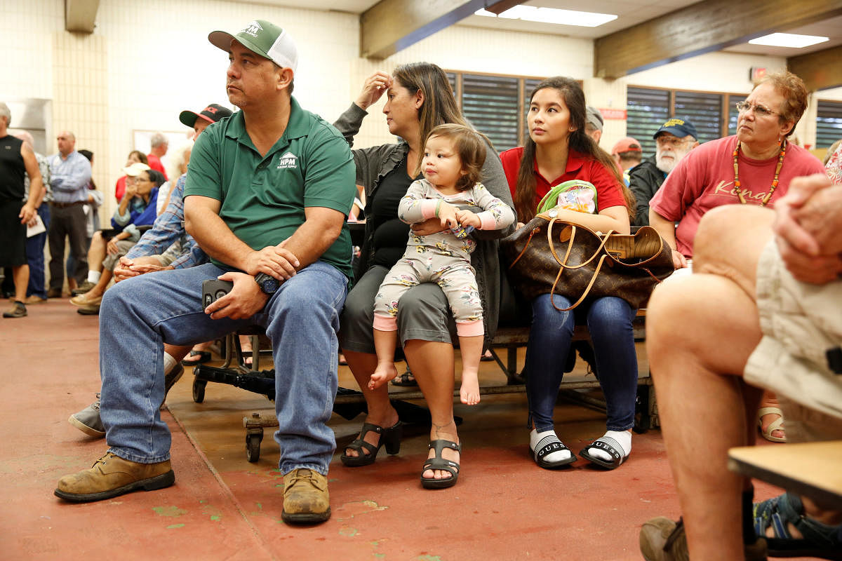 Puna District resident Ray Kaaihue and his family attend a community meeting on the ongoing eruptions of the Kilauea Volcano at Pahoa High and Intermediate School in Pahoa. Reuters photo