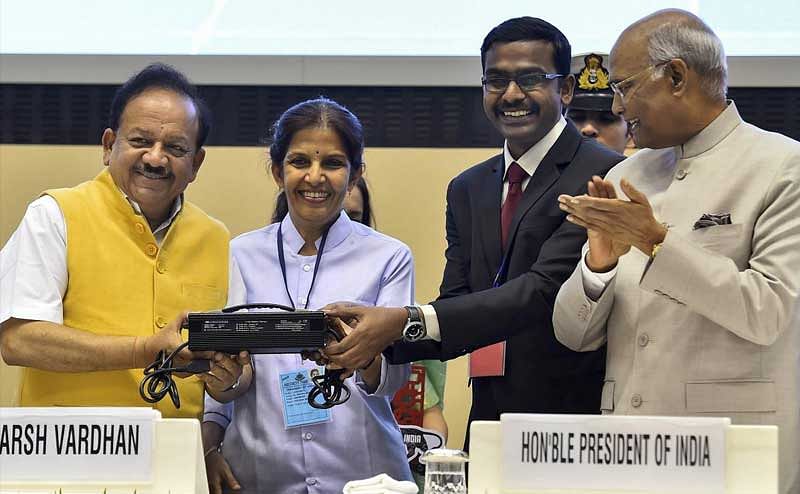 Minister for Science and Technology Harsh Vardhan launches the 'Product of the Year 2018: Charger for the Lithium Ion Battery' by M/s Ampere Vehicles, Coimbatore, during the inauguration of the 20th National Technology Day 2018 function in New Delhi on Friday. President Ram Nath Kovind is also seen. PTI