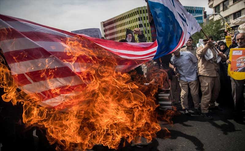 Iranians burn a U.S. flag during a protest against President Donald Trump's decision to walk out of a 2015 nuclear deal, in Tehran, Iran, May 11, 2018. REUTERS/Tasnim News Agency