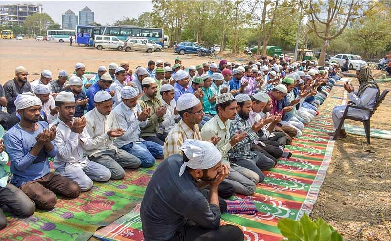 People offer namaz under police presence (unseen), after the recent disruptions by Hindu activists organisations, in Gurugram on Friday.PTI Photo