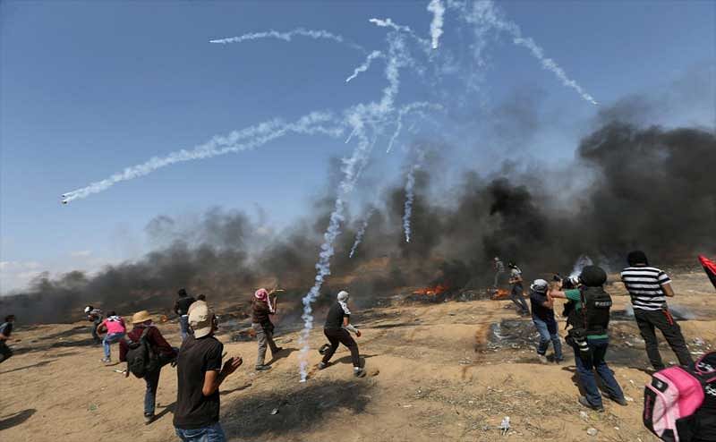 Tear gas canisters are fired by Israeli forces at Palestinian demonstrators during a protest demanding the right to return to their homeland, at the Israel-Gaza border in the southern Gaza Strip, May 11, 2018. REUTERS