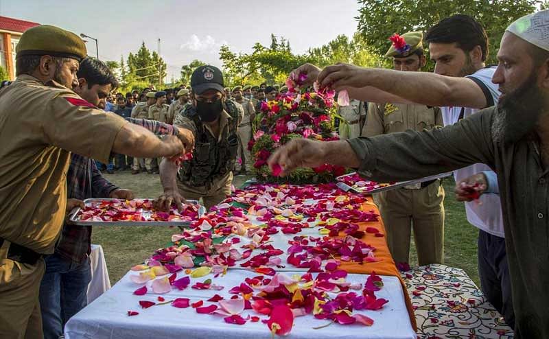 Police personnel pay floral tribute to SG constable Shamim Ahmad, who was killed in a militant attack at Wadwan, in Budgam on Friday. PTI photo.