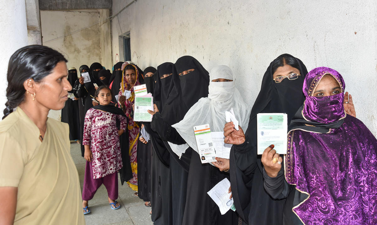 Women stand in Queue to exercise their franchise for Assembly Election at Afzalpur polling station in Kalaburagi District on Saturday. DH Photo
