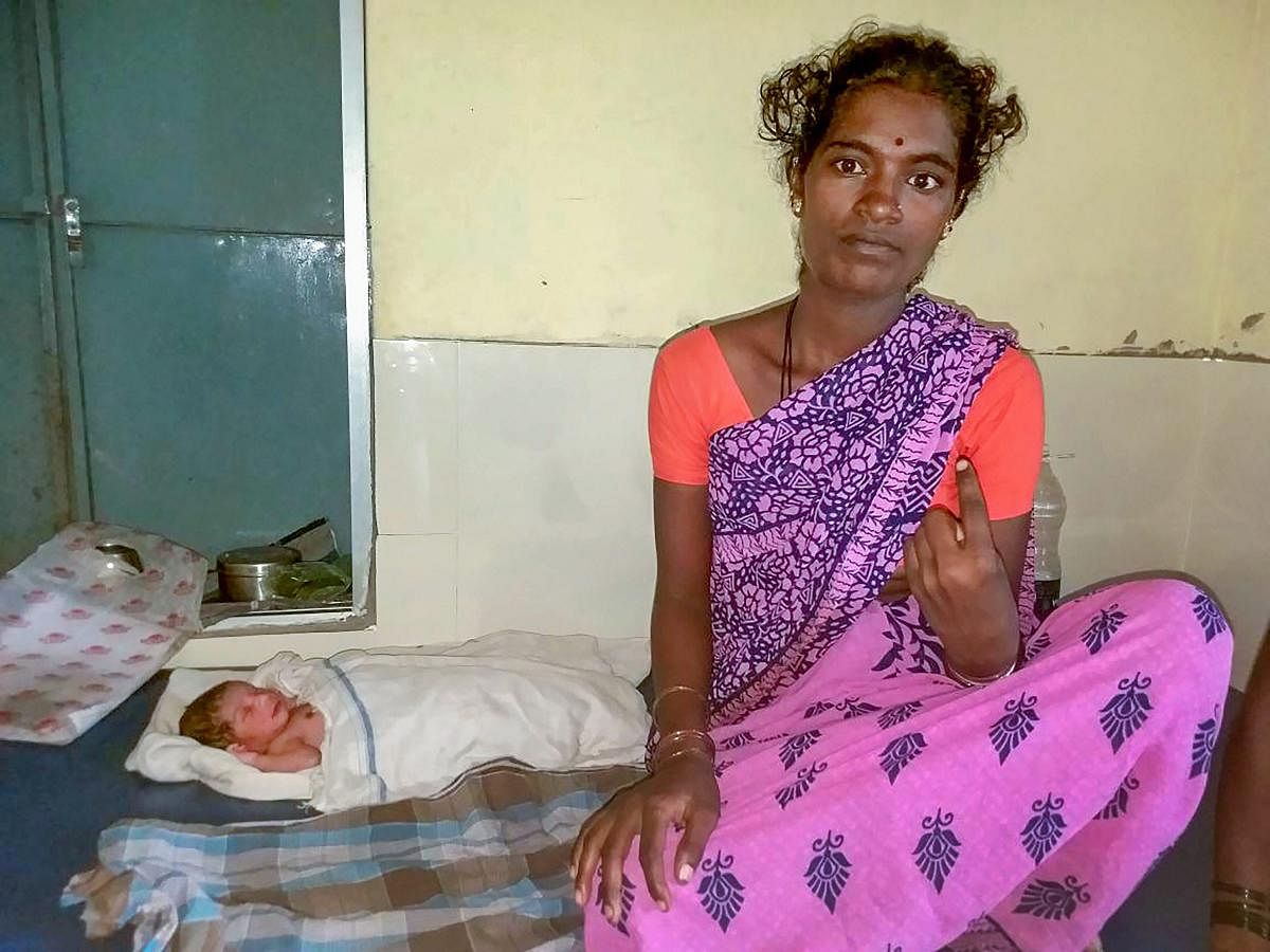 Kontemma with her newly born baby after casting her vote for Karnataka Assembly polls, at Yadgir on Saturday. PTI Photo