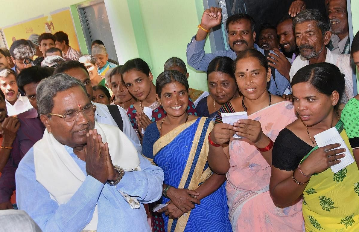 Karnataka Chief Minister Siddaramaiah greets his supporters after voting in the Karnataka Assembly elections 2018, at Hundi village in Mysore on Saturday. PTI Photo