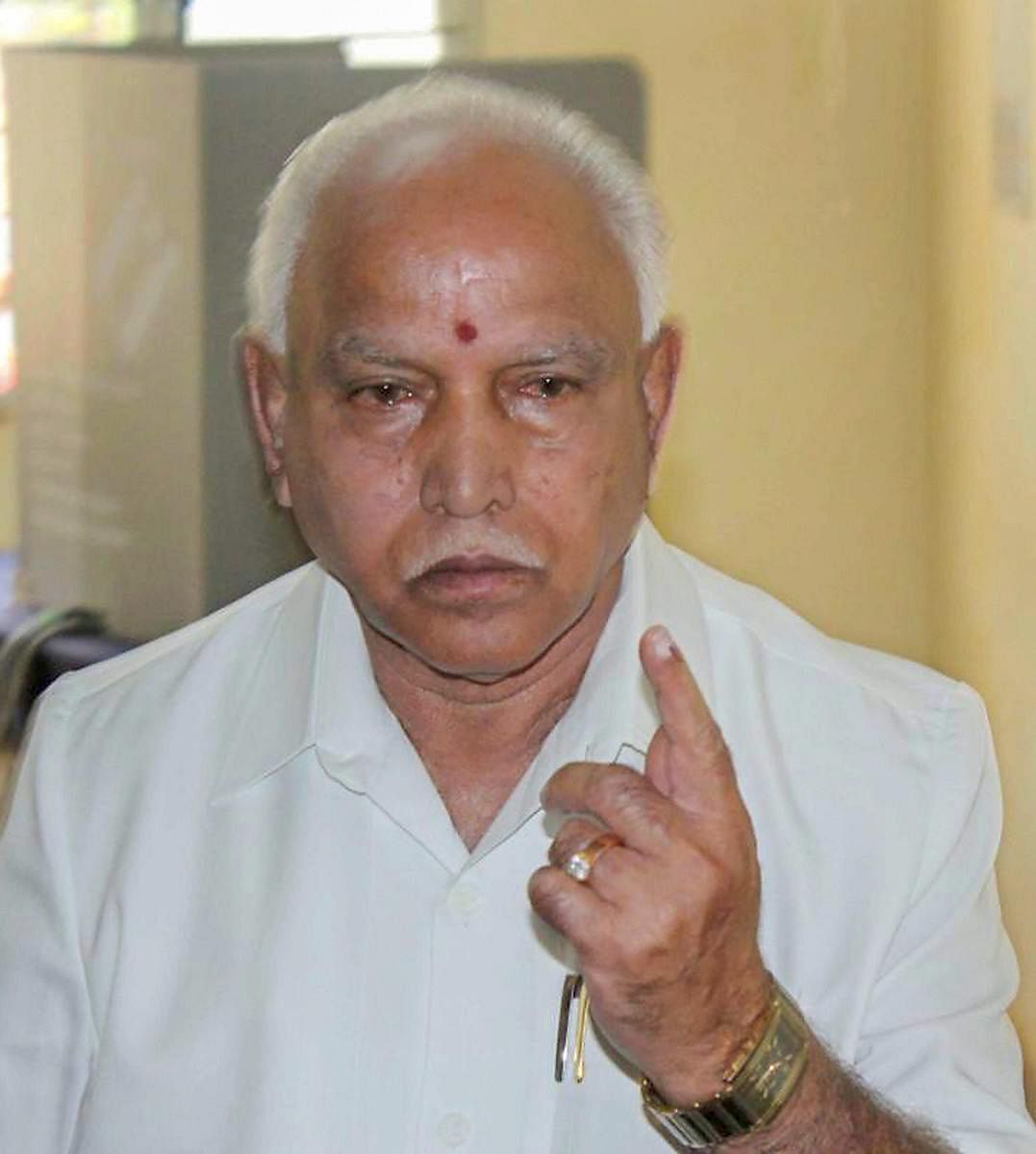 BJP's chief ministerial candidate B S Yeddyurappa shows his inked finger after casting for Assembly elections at Shikaripur in Shivamoga district on Saturday. PTI Photo