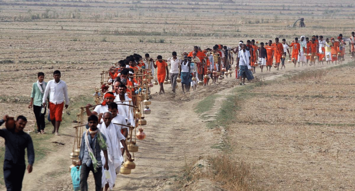 Hindu devotees (Kanwariyas) carry holy water of river Ganga to perform 'abhishek' at Padilla Mahadev temple, on the 1st day of Purshottam (Adhimas) of Hindu calendar, in Allahabad on Wednesday. PTI Photo