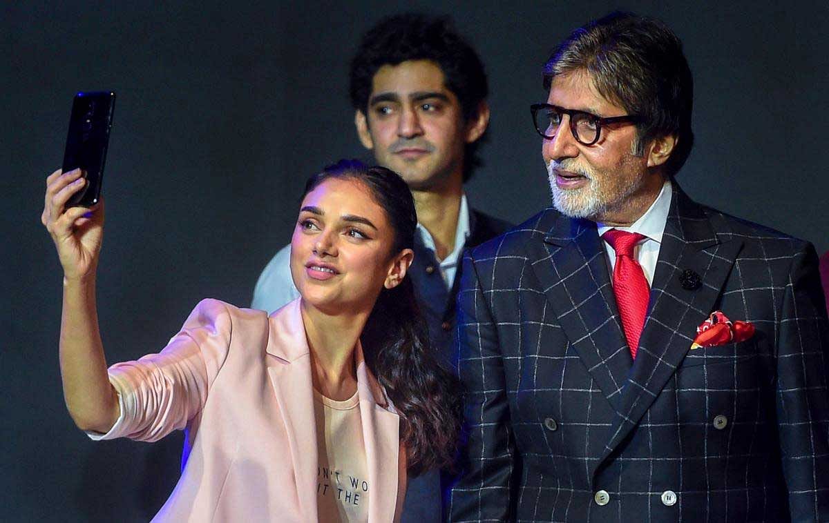 Bollywood actors Amitabh Bachchan and Aditi Rao Hydari take selfie during a phone launch in Mumbai on Thursday. PTI Photo