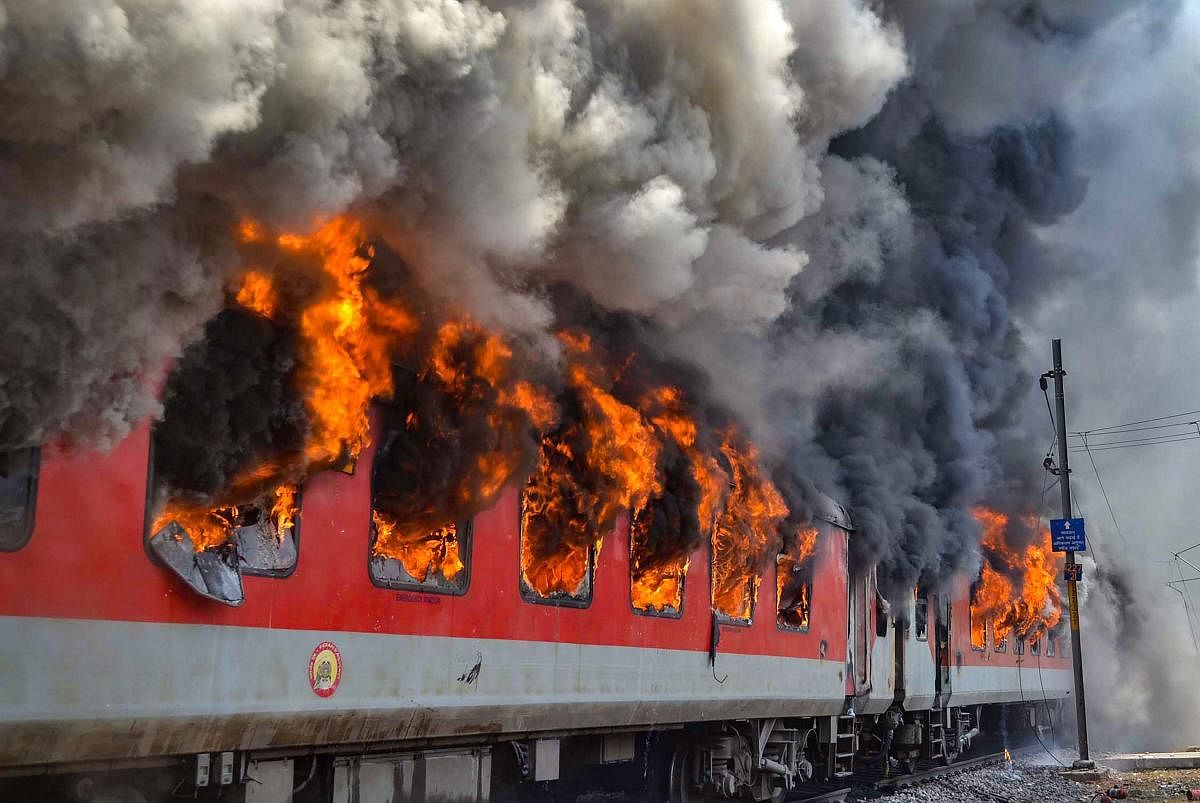 Smoke billows out of two bogies of the Andhra Pradesh AC Superfast Express which caught fire near Gwalior. PTI Photo