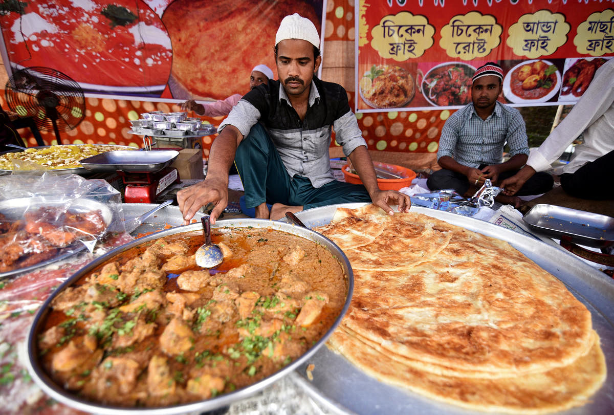 Vendors prepare delicacies at a roadside shop during the holy fasting month of Ramadan in Guwahati. Reuters Photo