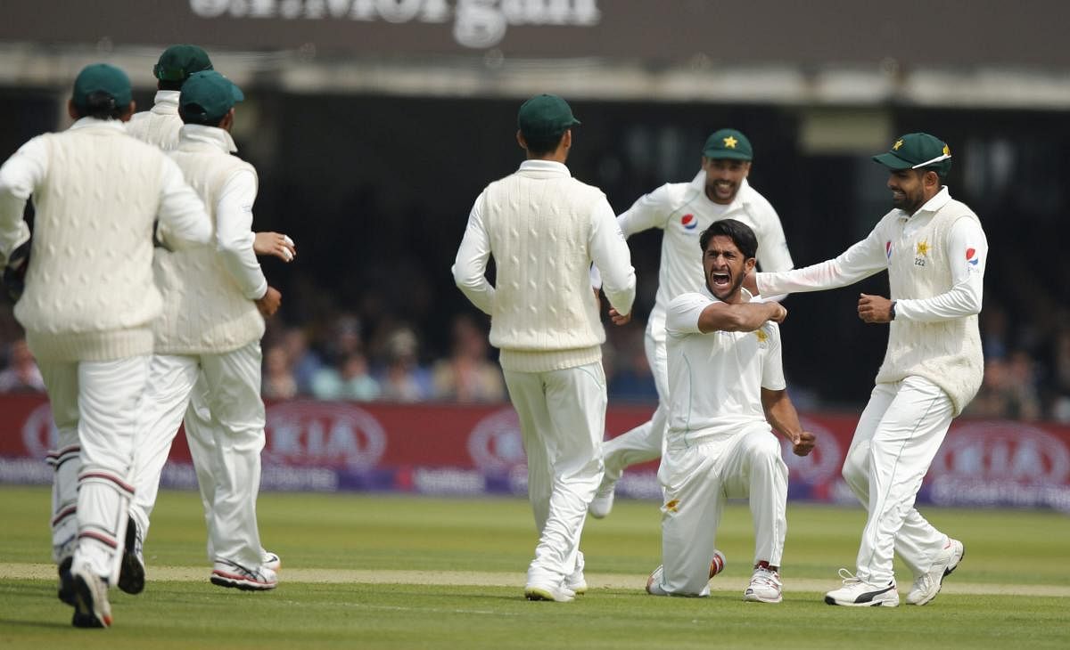 Pakistan's Hasan Ali celebrates with teammates after taking the wicket of England's Joe Root, caught behind, during the first day of play of the first test cricket match between England and Pakistan at Lord's cricket ground in London, Thursday, May 24, 2018. AP/PTI